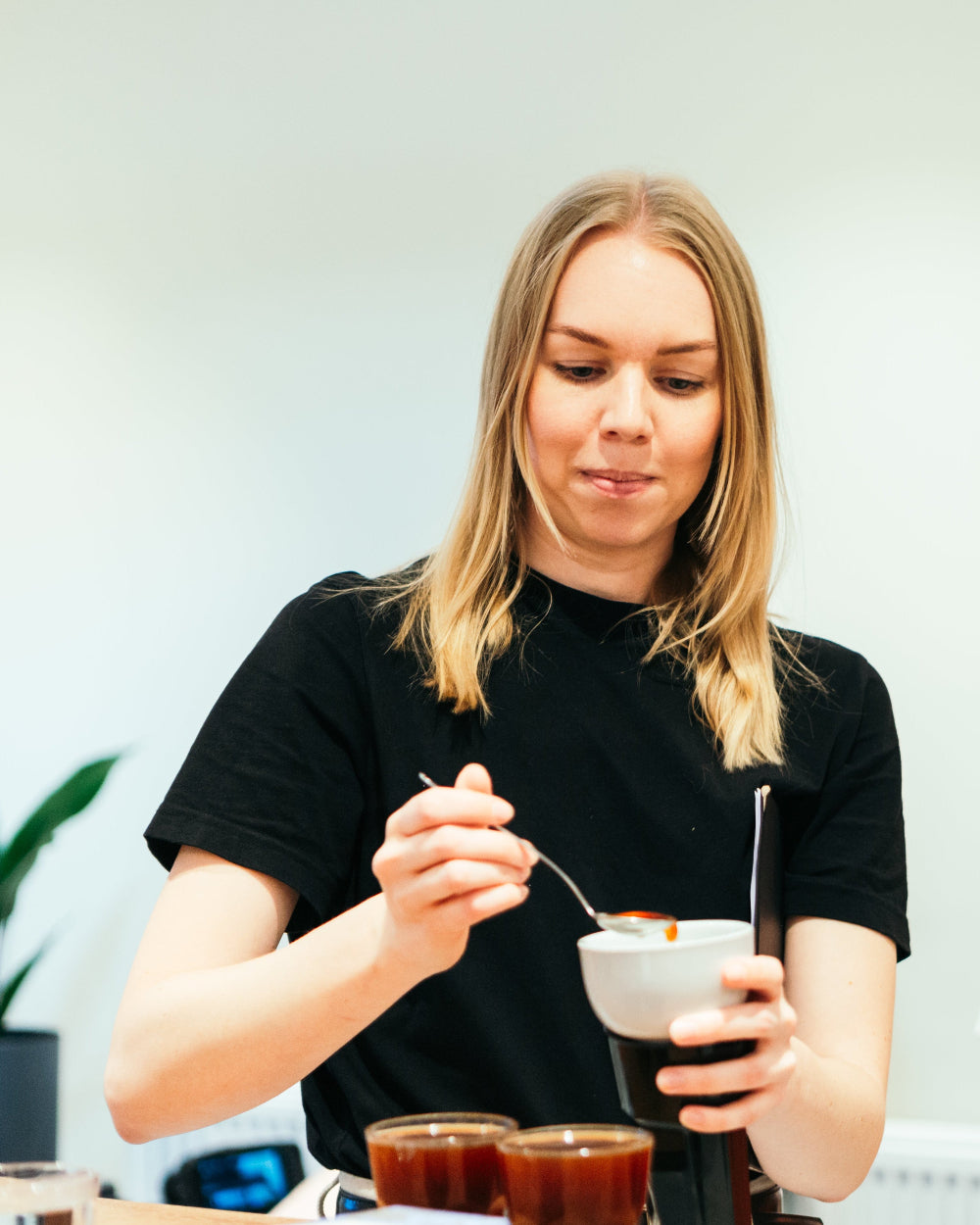 A woman participating in a coffee tasting class.
